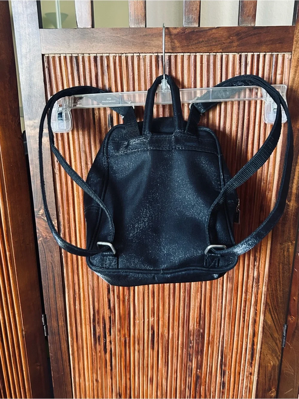 Backpack mini style. Black little purse with lots of compartments and zippers.